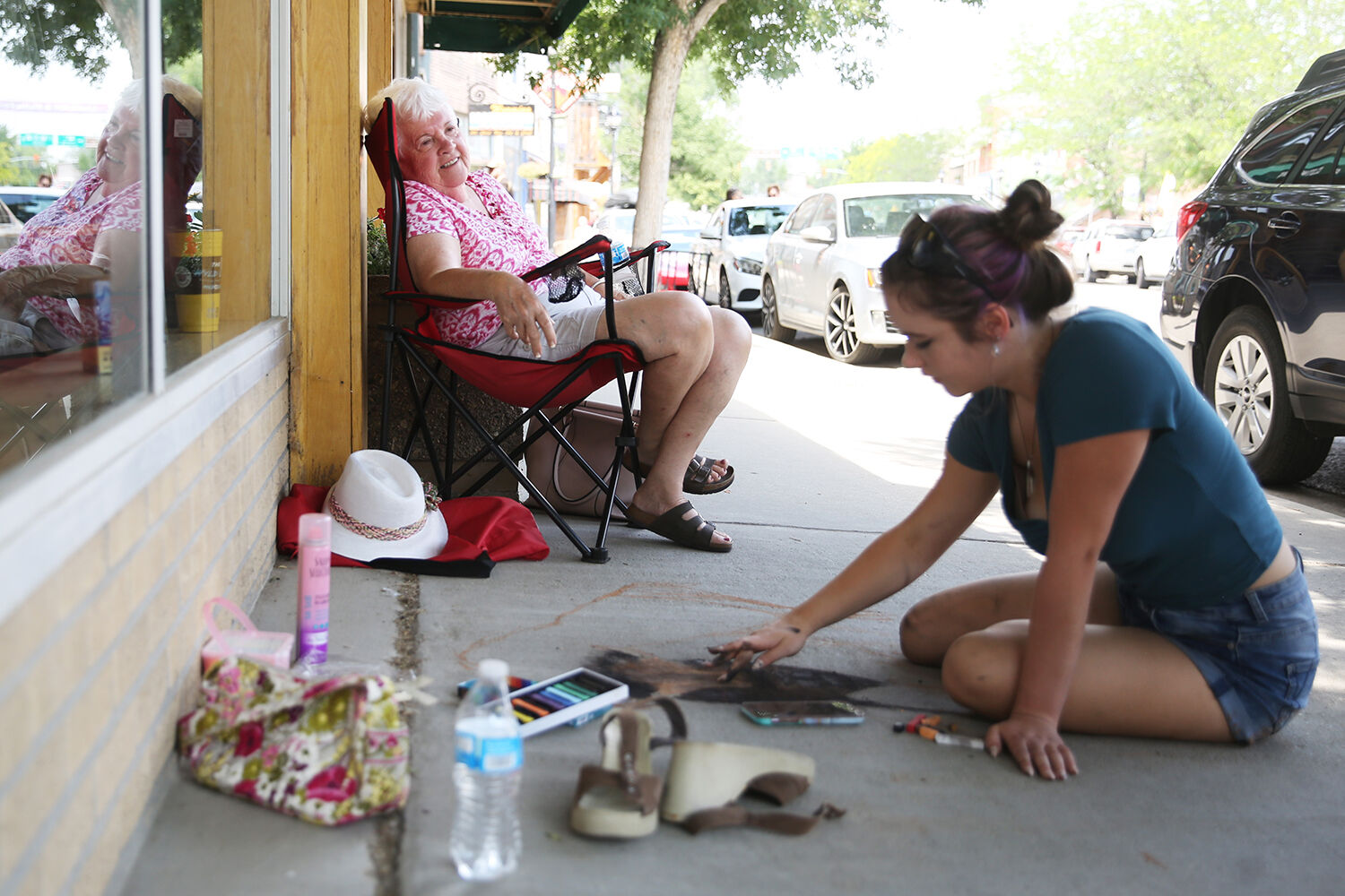 Wilma Wallace watches the work from her lawn chair